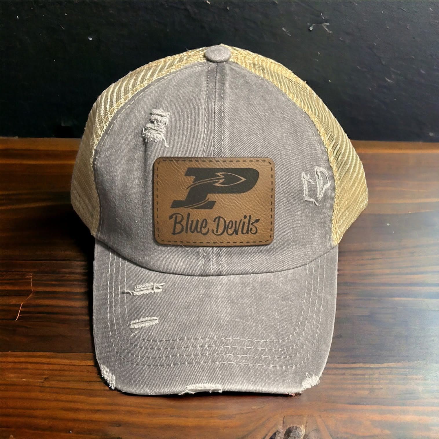 Distressed grey trucker hat with a brown leatherette Blue Devils patch