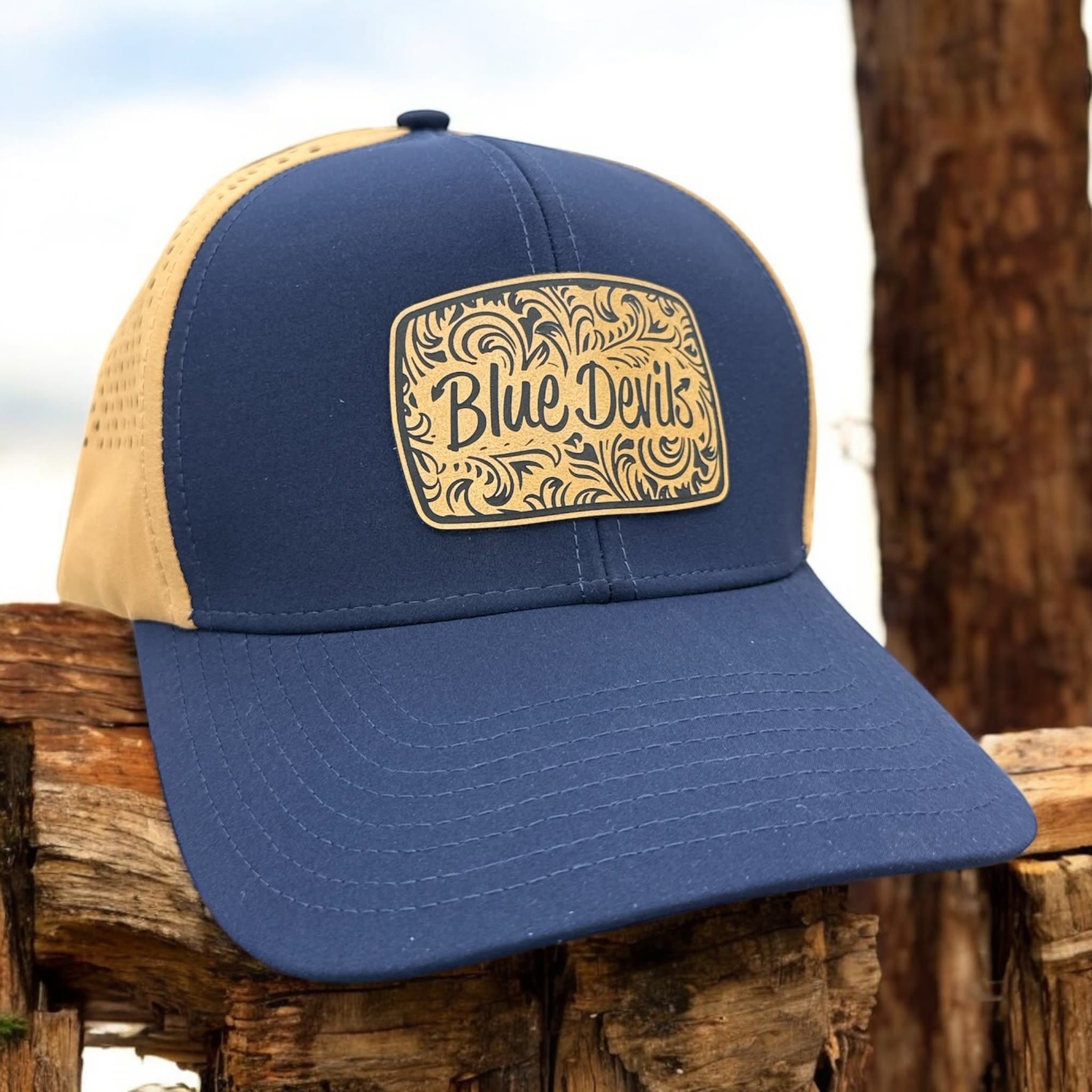 Navy and khaki trucker hat with a filigree-engraved leatherette Blue Devils patch