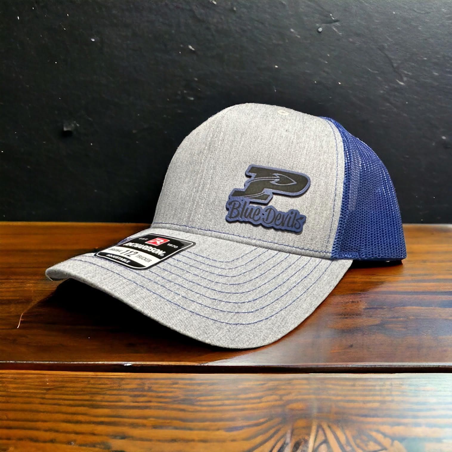 Side angle of a heather grey and navy Richardson 112 with a navy Blue Devils patch
