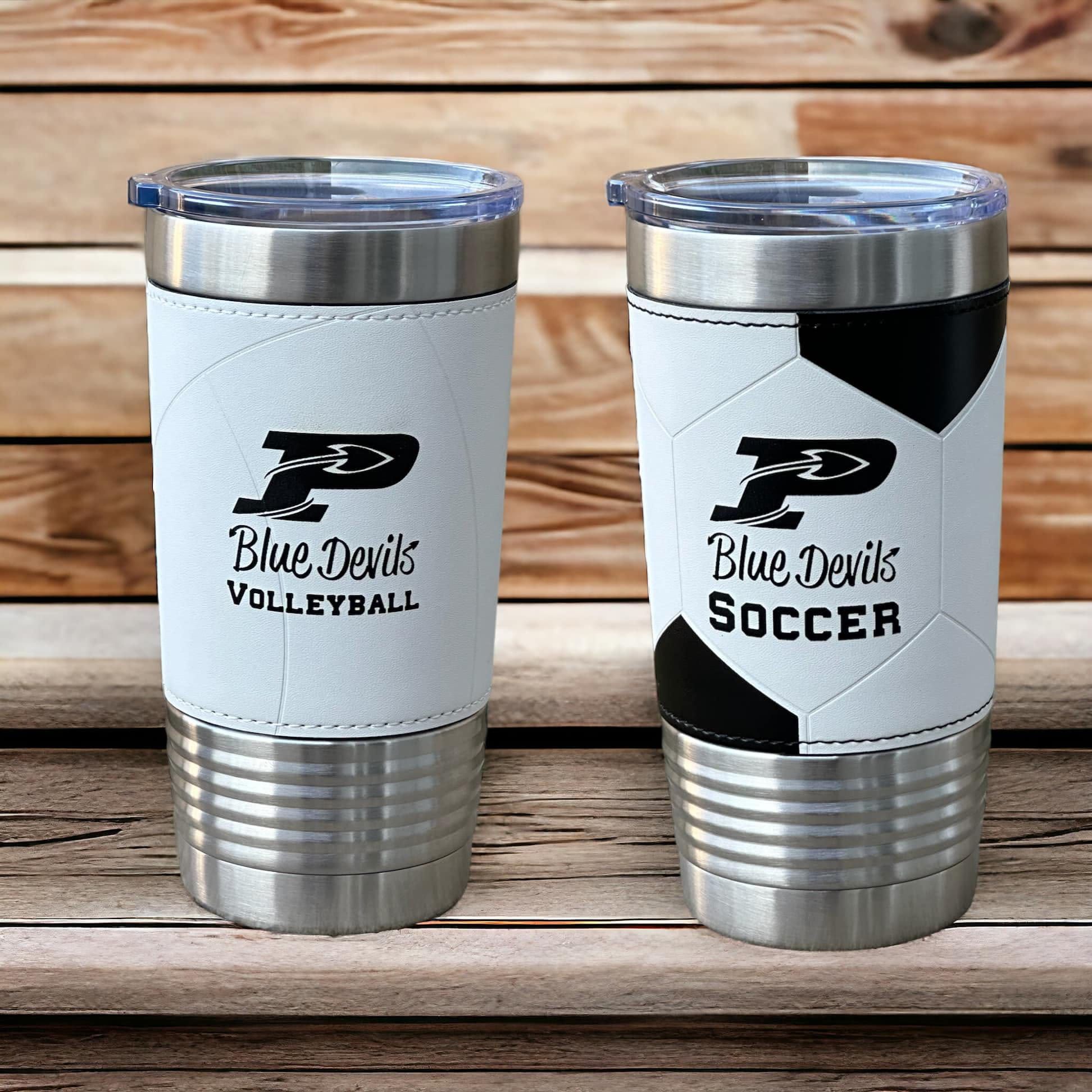 Two white leatherette-wrapped tumblers engraved Blue Devils Volleyball and Blue Devils Soccer