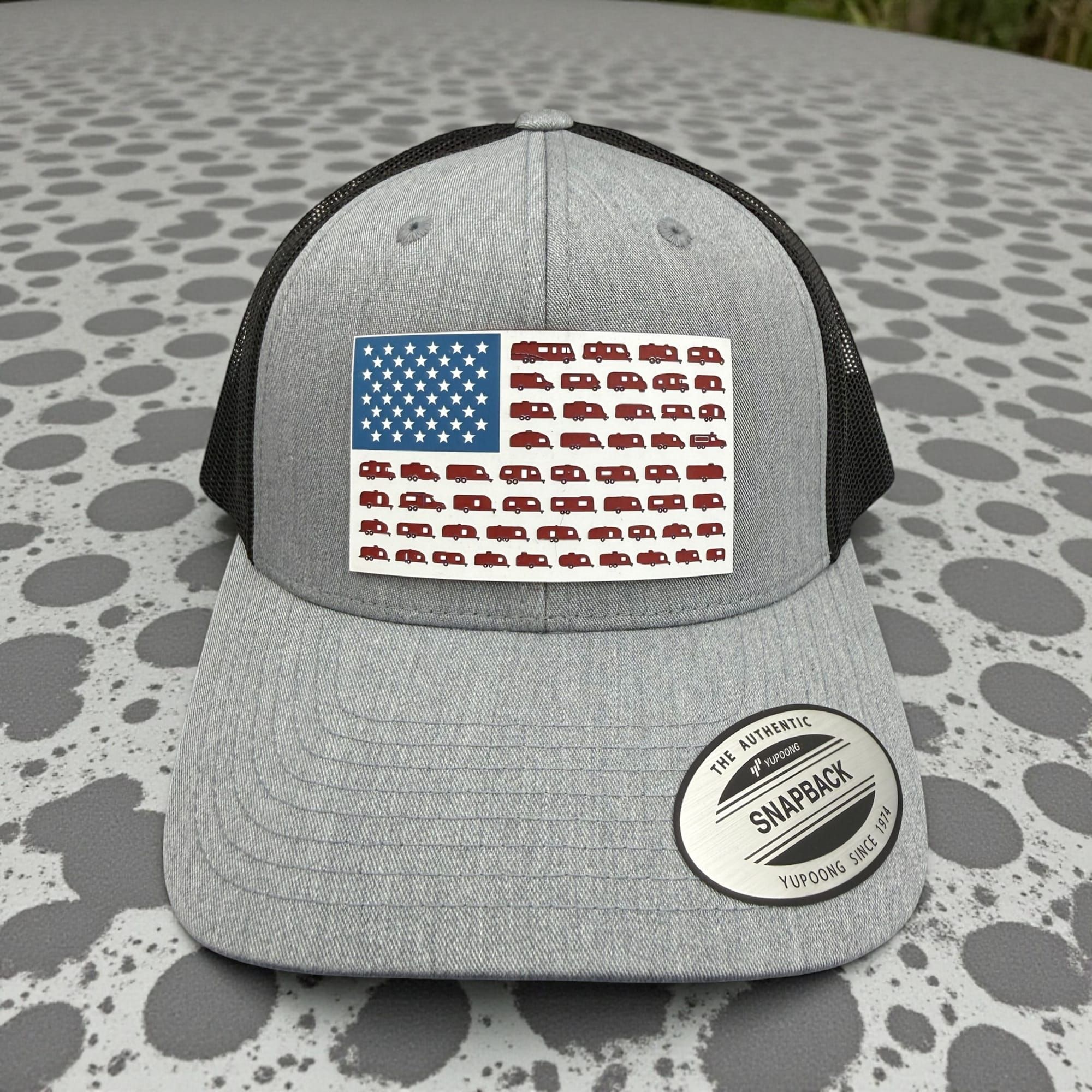 Heather grey snapback with an American flag patch made of camper silhouettes