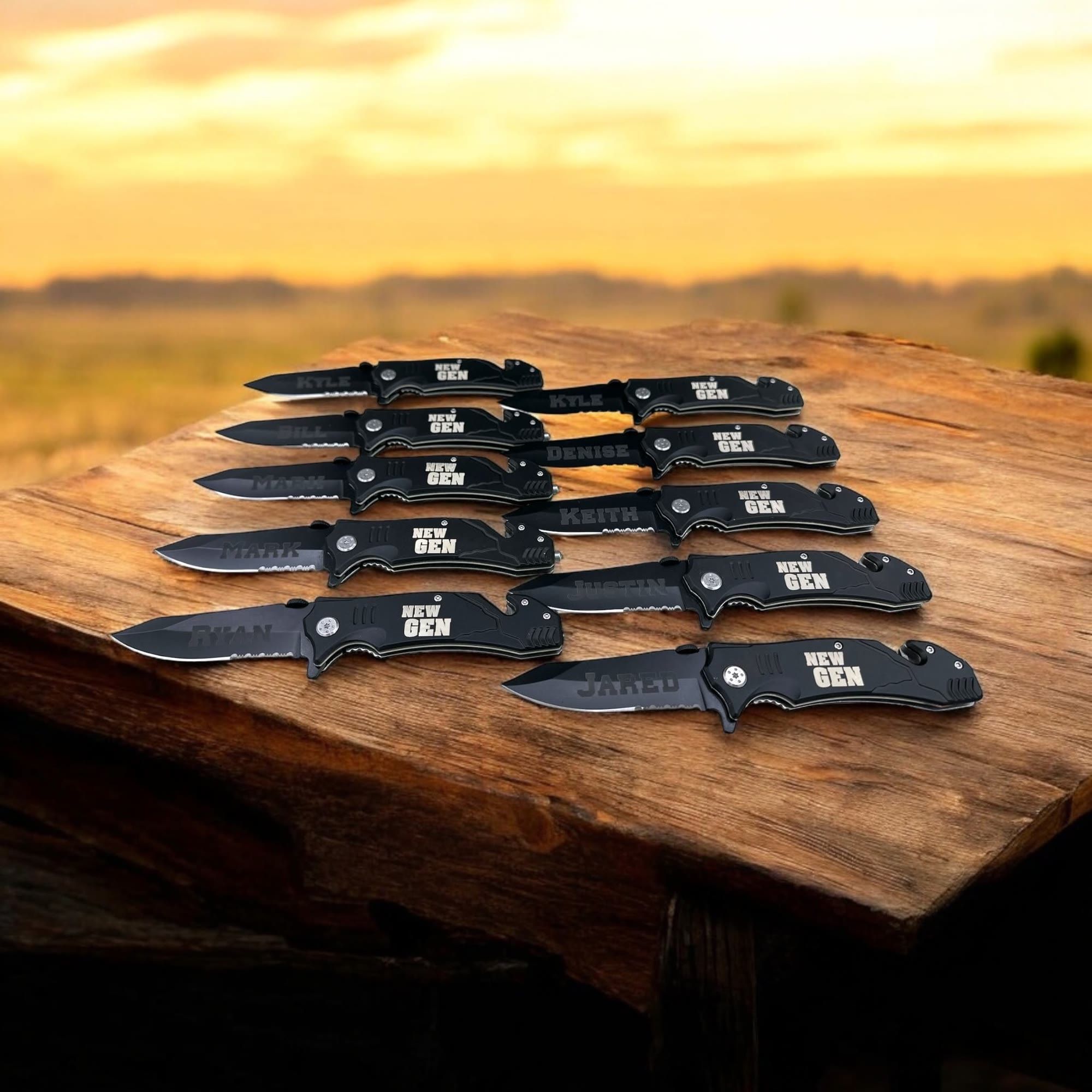 Ten black folding knives engraved with the New Gen logo and individual names